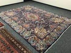 A large Persian carpet on blue ground,
