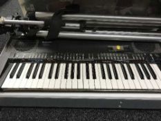 A Technics SX-K200 keyboard and a large camera tripod