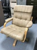 A leather adjustable swivel armchair