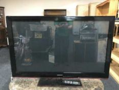 A Samsung plasma 50 inch TV with lead and remote
