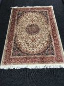 A Keshan fringed rug with silk pile on red