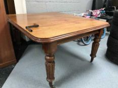 A Victorian wind out dining table with two leaves and handle