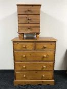 A pine five drawer chest and bedside chest