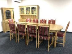 A circular blonde oak dining table with two leaves and six chairs and set of four chairs