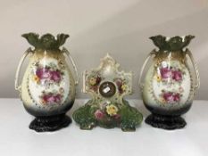 An early 20th century china mantel clock and a pair of vases