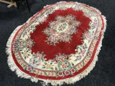 A Chinese oval embossed floral rug