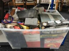 A box of power tools, hand tools, work lights, car parts,
