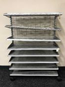 A set of eight tier metal shelves on wheels