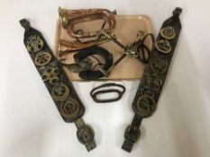 A tray of horse brasses, stirrups,