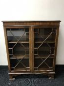 A mahogany glazed door bookcase on bracket feet