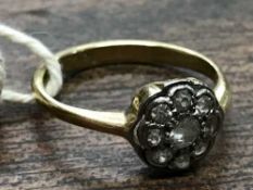 An 18ct gold diamond cluster ring set with small old cut stones