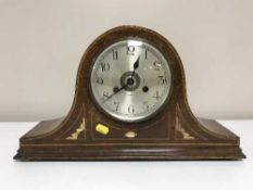 An inlaid mahogany mantel clock with silvered dial