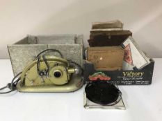 A boxed Gem projector and a box of film reels,