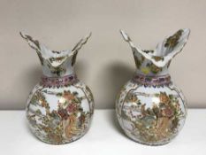 A pair of white decorative oriental style vases