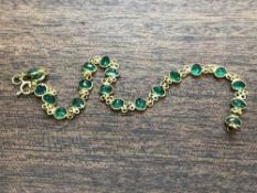 An 18ct gold emerald bracelet