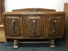 An early 20th century carved oak sideboard