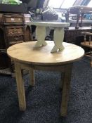 A reclaimed pine circular table and a painted pine stool