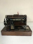 A mahogany cased Singer hand sewing machine