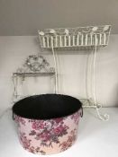 A large circular metal planter and a white metal plant trough & wall shelf