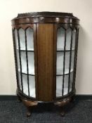 A mahogany d-shaped display cabinet