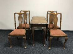 A walnut drop leaf table and four oak chairs