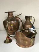 An antique hammered copper vase,