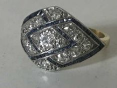 An 18ct diamond and sapphire Art Deco style cluster ring