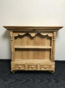 A pine wall mounted plate rack