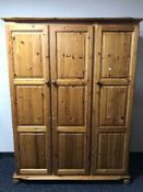 A pine triple door wardrobe