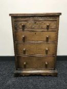A carved oak four drawer chest