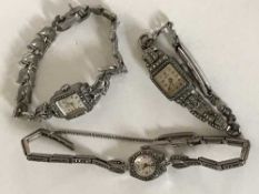 A silver marcasite wrist watch together with two other similar watches (3)