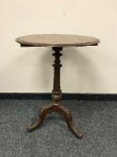 A carved mahogany occasional table of tripod base