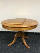 An oval pine extending table with leaf