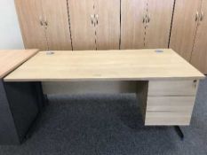 A single pedestal desk with swivel armchair