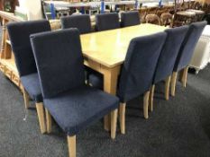 A large beech kitchen table fitted a drawer and eight dining chairs