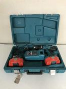 A Makita 18 volt electric drill with battery and charger