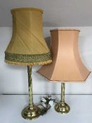 Two brass column table lamps with shades