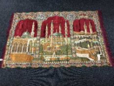 A fringed wooden wall hanging of an Indian temple