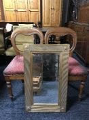 A pair of balloon back chairs and a gilt framed mirror