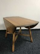 An Ercol elm drop leaf table