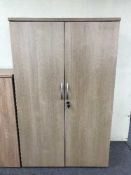 A double door office stationary cupboard,