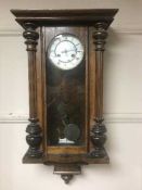 A mahogany wall clock with enamel dial