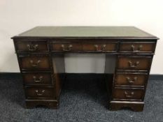 A Georgian style writing desk inset green leather panel