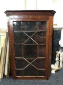 A Victorian inlaid mahogany hanging corner cabinet