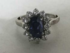 An 18ct white gold diamond sapphire cluster ring