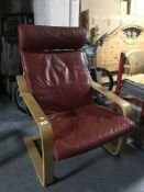 A beech framed red leather armchair