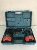 A Makita 18 volt electric drill with battery and charger