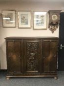 A continental triple door oak side cabinet