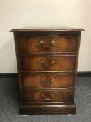 A reproduction mahogany filing chest with tooled leather top