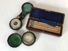 Two pocket compensated barometers, in original cases,